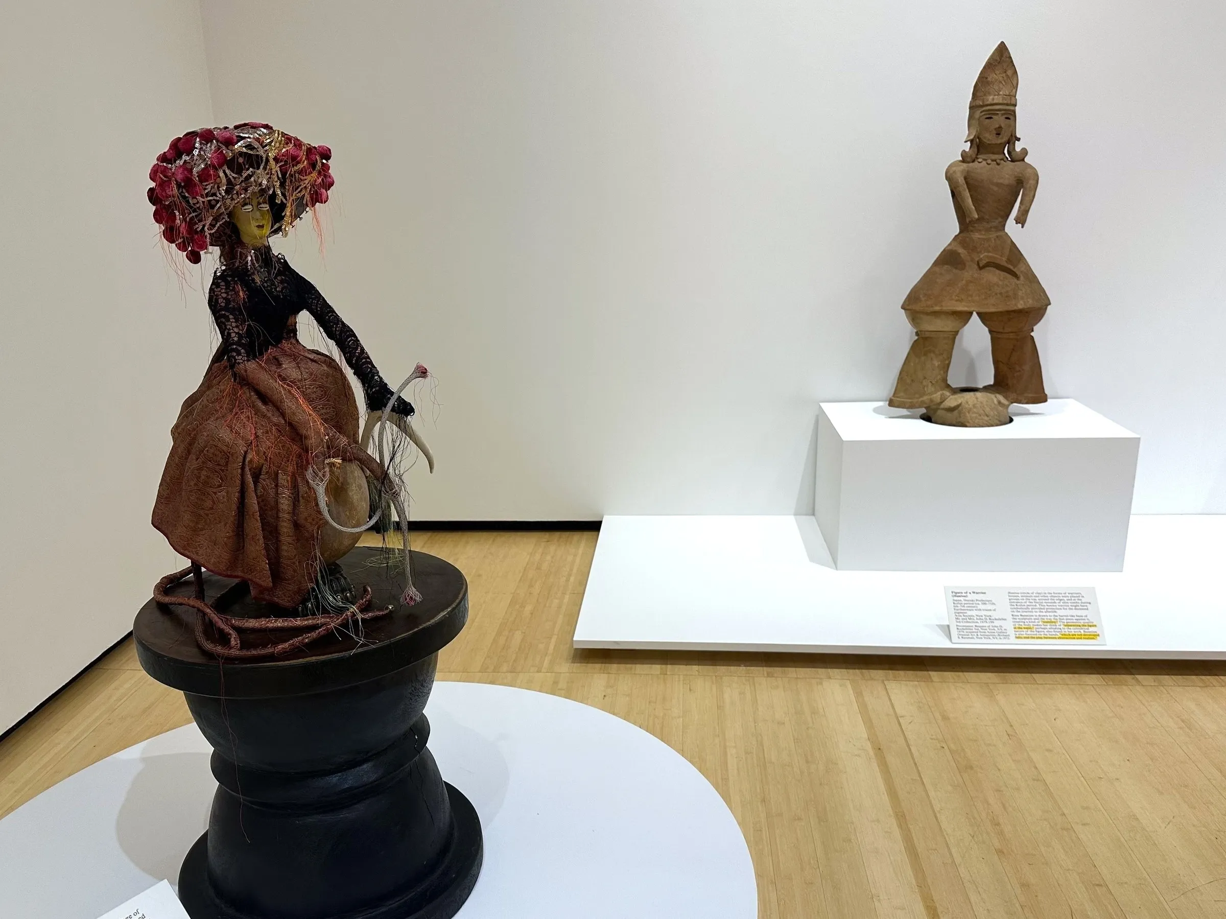 Rina Banerjee, “Native, migrant naturally” (2018) (left) and “Figure of a Man” (6th–7th century) from Japan, Ibaraki Prefecture, Tumulus period, earthenware with traces of pigment (right) (all photos Lakshmi Rivera Amin/Hyperallergic)
